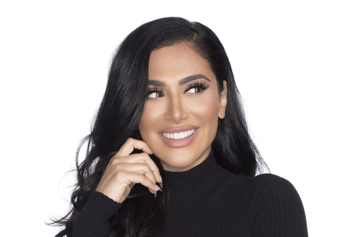 Huda Kattan smiling